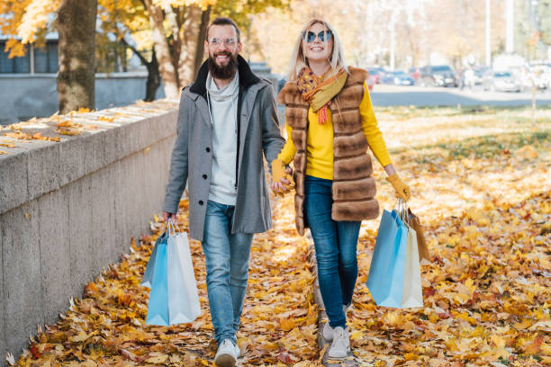 istock autumn fun couple shopping sidewalk leaves fall 1159292289