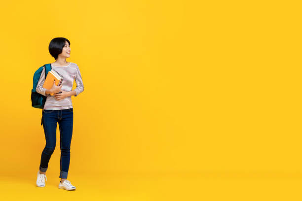 istock Happy girl student with bag and books 1159293083
