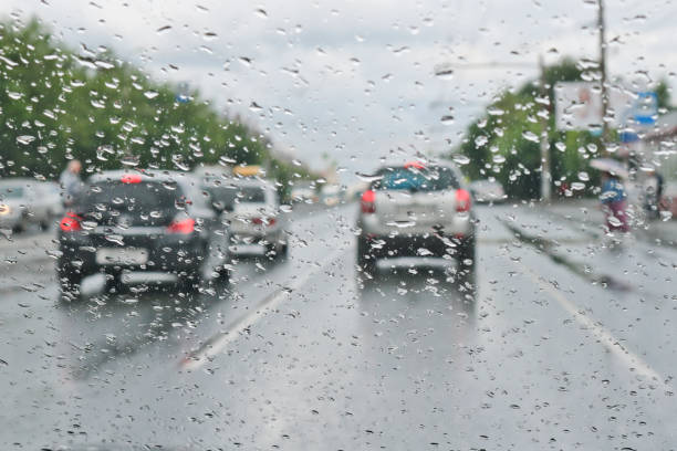 istock Raindrops on the windshield of the car. Selective focus. The view from the car window on the roadway. Bad visibility. 1159293395