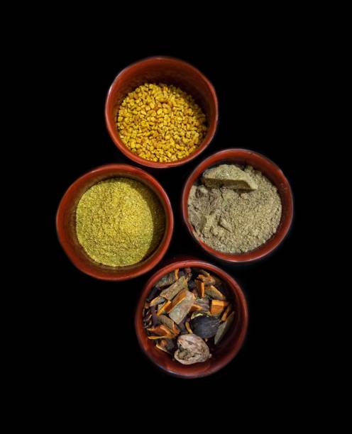 istock Top view mix indian spices and herbs different size terracotta pots isolated on black background. 1159293619