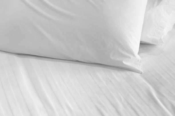 istock white soft pillow on the bed room interior background 1159295495