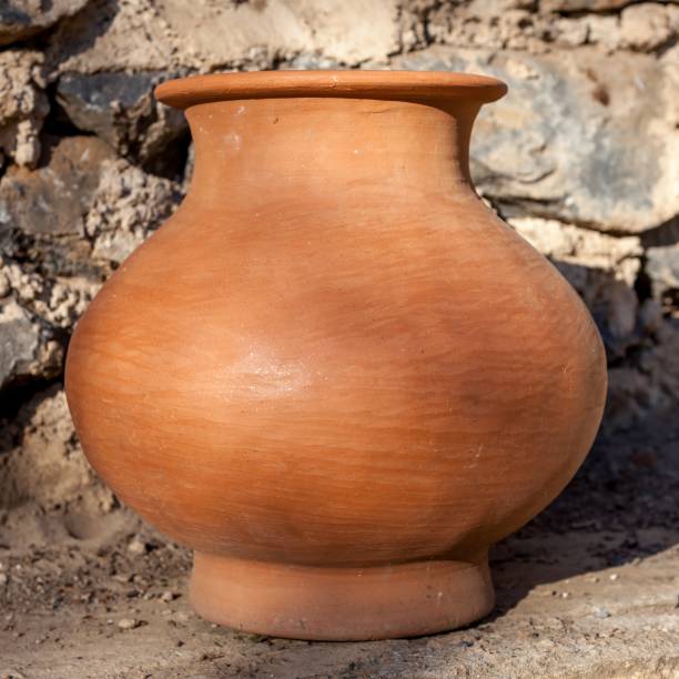 istock Single traditional Clay Pot with brick wall at background in Myanmar. 1159297408