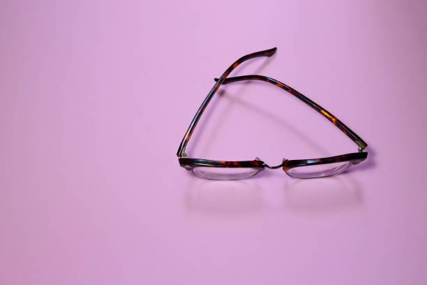 istock Spectacles frame on pink background. Brown eyewear on top view 1159298234