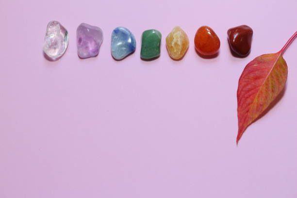 istock Chakra healing stones and one leaf on pink millennial background with copy space for text 1159298238