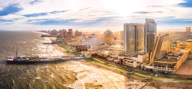 Late afternoon aerial panorama of Atlantic City Late afternoon aerial panorama of Atlantic city along the boardwalk. Atlantic City achieved nationwide attention as a gambling resort and currently has nine large casinos. new jersey stock pictures, royalty-free photos & images