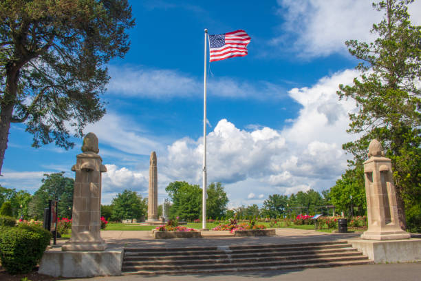 An American flag flies at the entrance to the Walnut Hill Park rose garden in New Britain, Connecticut stock photo