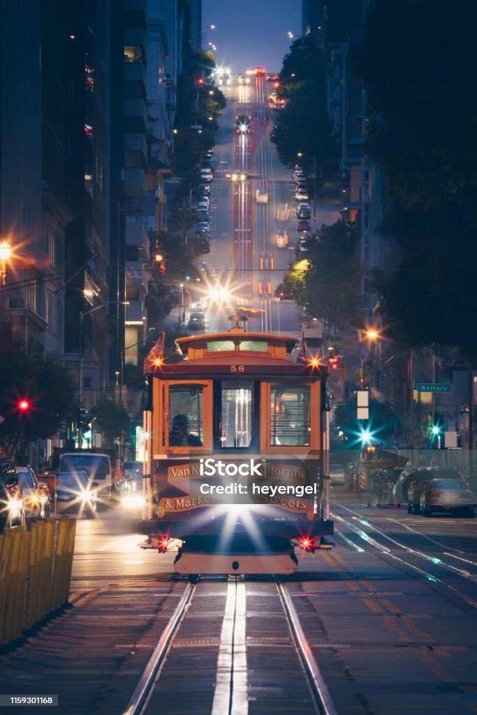 Klassischer Blick auf historische traditionelle Seilbahnen, die nachts auf der berühmten California Street mit Stadtbeleuchtung fahren, San Francisco, Kalifornien, USA - Lizenzfrei San Francisco Stock-Foto