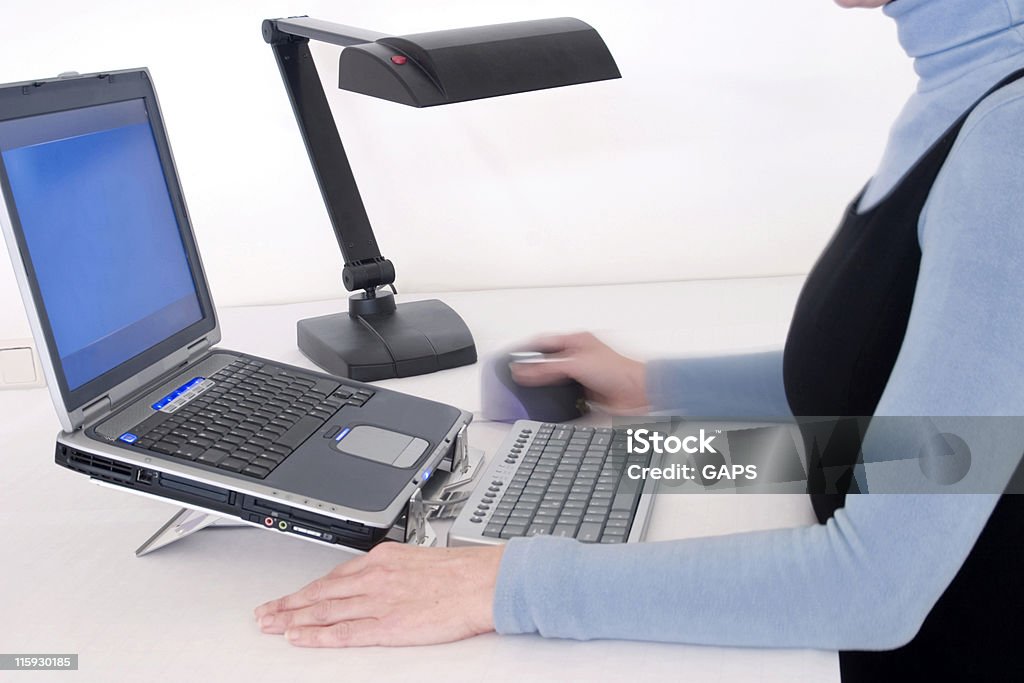 secretary working on a laptop computer secretary working on a laptop computer on a clean white office desk Ergonomics Stock Photo