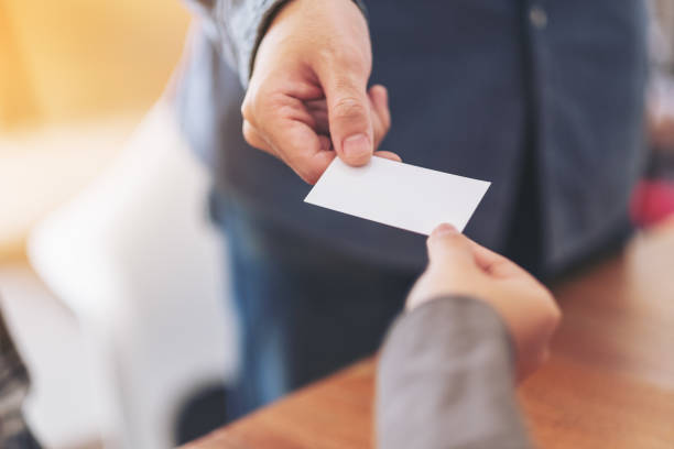 istock businessman holding and exchanging empty business card 1159307155