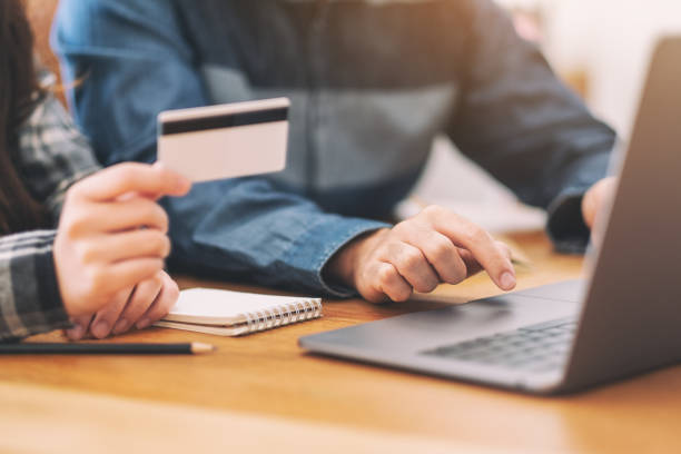 istock Businessman using credit card for shopping online 1159307156