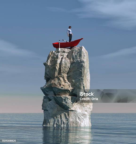 Man In A Boat Stuck On A Big Rock In The Middle Of The Ocean Stock Photo - Download Image Now
