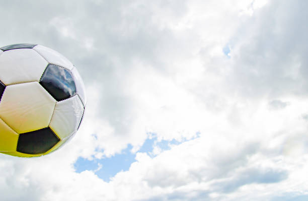 istock Soccer ball on a cloudy sky background. 1159309625