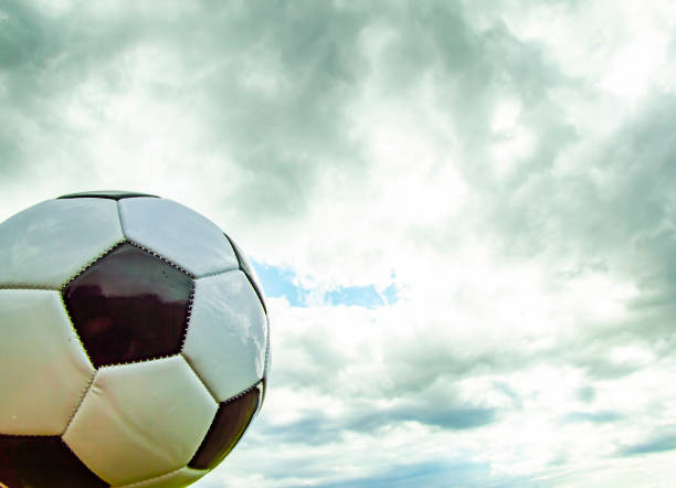istock Soccer ball on a cloudy sky background. 1159309628
