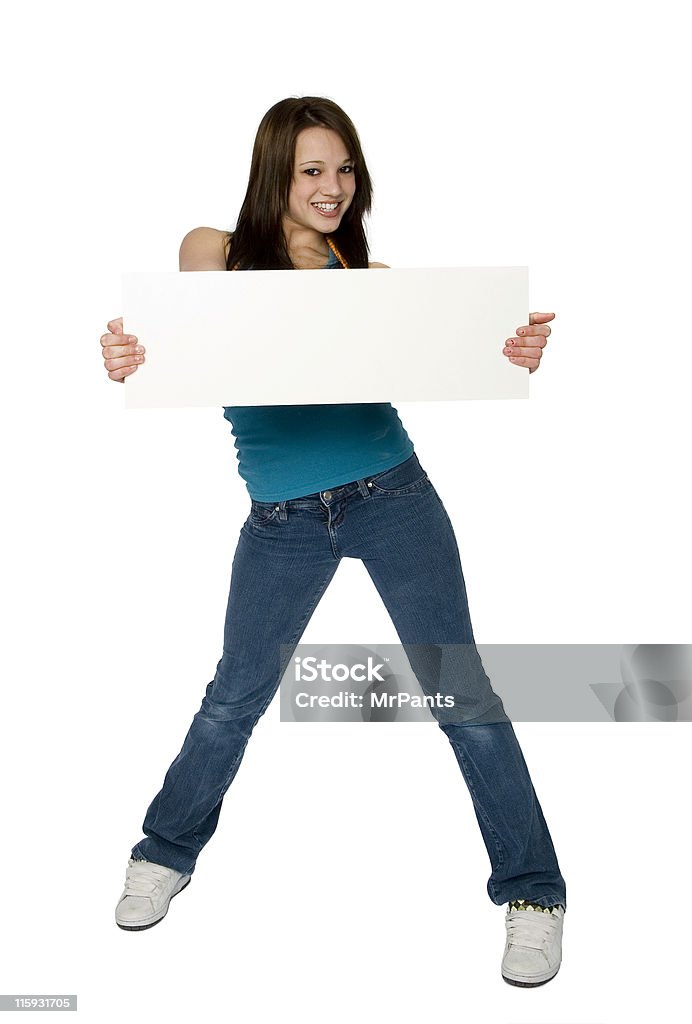 Attractive Teenage Girl Holding Blank Sign Isolated on White Background Full length photo of attractive brunette teenage girl standing, holding blank sign, isolated on white background Adolescence Stock Photo