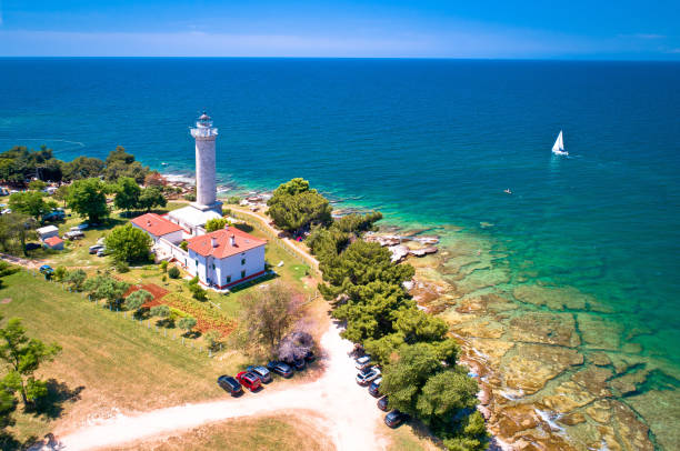 istock Savudrija lighthouse and turquoise crystal clear rocky beach aerial view 1159317841