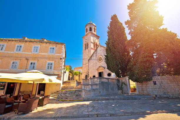 Town of Cavtat stone church sun haze view Town of Cavtat stone church sun haze view, south Dalmatia region of Croatia cavtat photos stock pictures, royalty-free photos & images