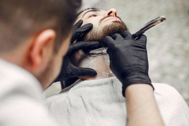 istock Stylish man sitting in a barbershop 1159320316