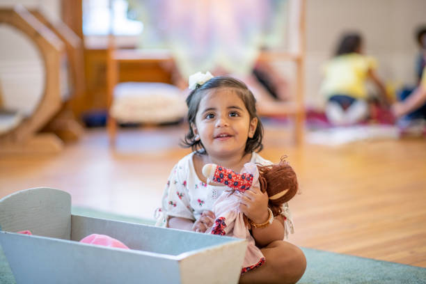 istock Toddler plays with a doll 1159321540