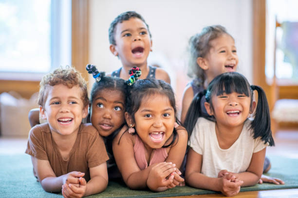 istock Group of diverse kids in a pile on the floor 1159321544