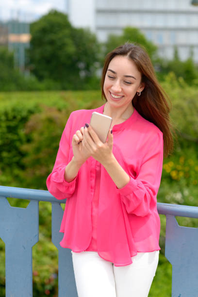 istock Young woman reading a text message on her mobile 1159324035