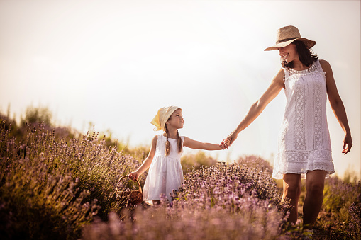 Mother and daughter playing in a wildflower  field