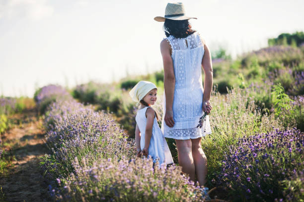 istock Mother and daughter playing in a wildflower  field 1159324799