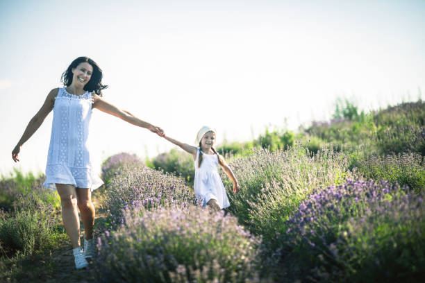 istock Mother and daughter playing in a wildflower  field 1159324904