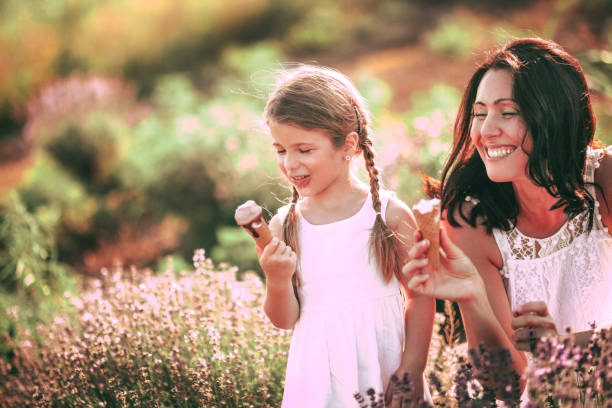 istock Mother and daughter playing in a wildflower  field 1159324943