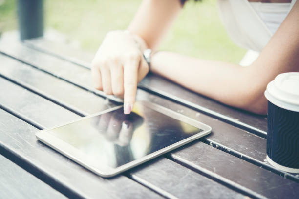 Woman Reading Online Article & Explore Online Feminist Website from tablet  and drinking coffee. Searching Blog, Content to find Best Literary Fiction Websites. Smart woman's reading conceptual image