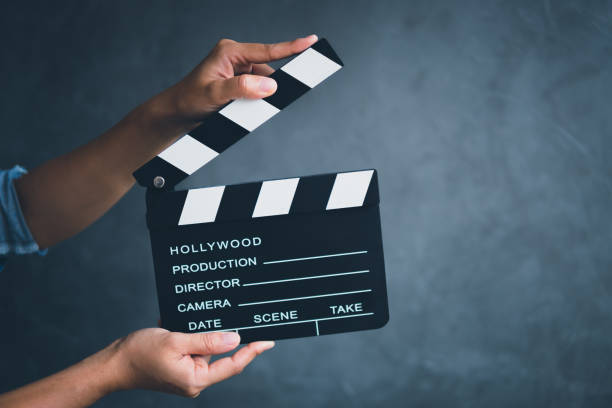 istock Women hands holding clapper board for making video cinema in studio. 1159326795