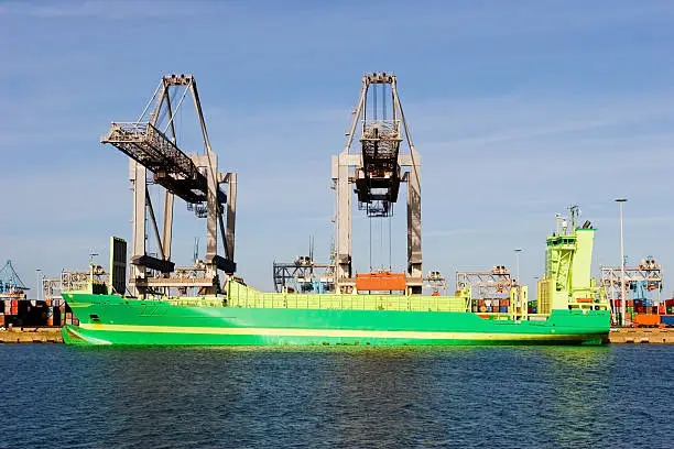 Green containership loading containers