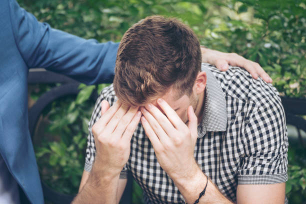 istock Guys Sharing Life Problems Always Support Best Friends. Friends Getting Down Heart Broken. Sad Man sitting outdoor in the park feeling sadness has a problems Life Crisis. Best Friend Mental Concept. 1159328660