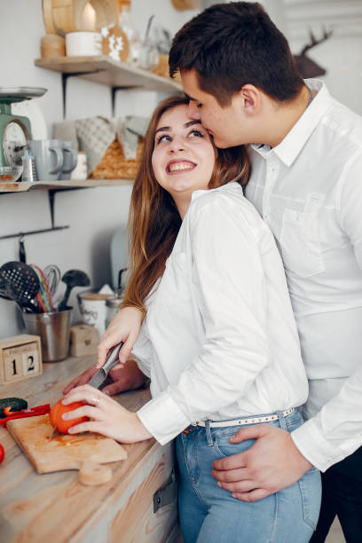 istock Beautiful couple prepare food in a kitchen 1159329614
