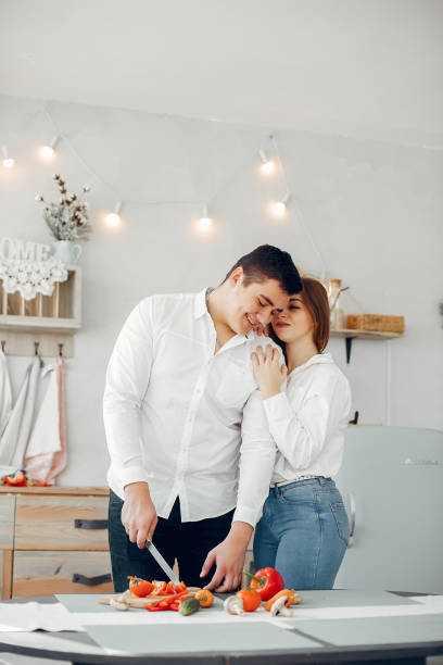 istock Beautiful couple prepare food in a kitchen 1159330466
