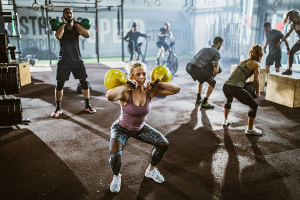 istock Large group of athletic people having gym training in a gym. 1159331281