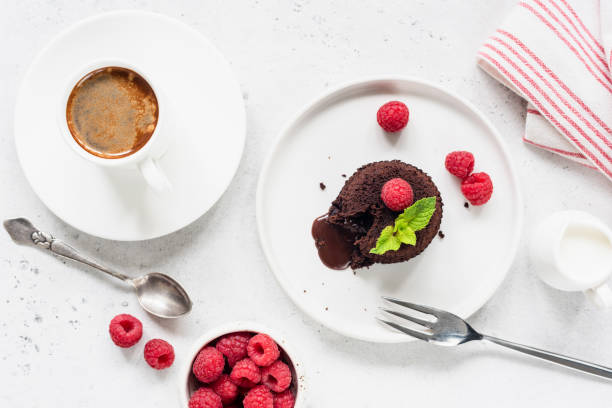 istock Chocolate cake with raspberries and cup of coffee 1159331520