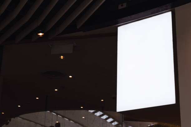 istock Blank white screen vertical signage mockup hanging on ceiling. Signboard for advertisement design in a shopping center, gallery. 1159331665