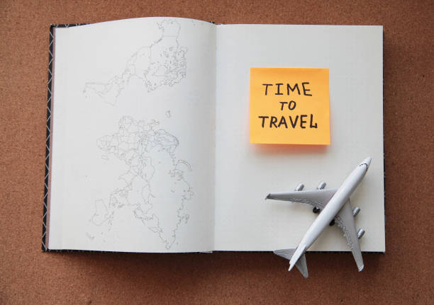 istock Travel concept with plane and notebook. Top view. Flat lay. 1159332361
