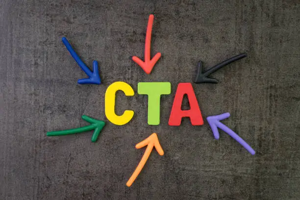 Photo of CTA, Call to action in advertising and communication concept, multi color arrows pointing to the word CTA at the center of black cement chalkboard wall