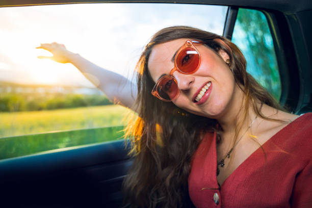 istock Girl at car window enjoying wind 1159334888