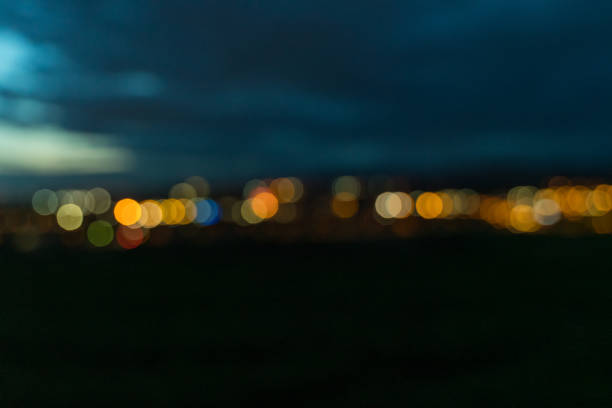 Defocused city lights on the horizon at twilight