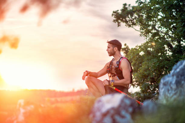 istock Trail runner succeeding by reaching the top of a mountain 1159335531