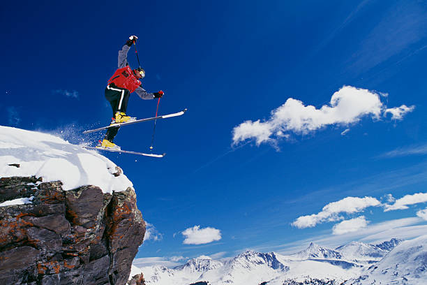 istock Snow Skier Jumping off Rock 115933874