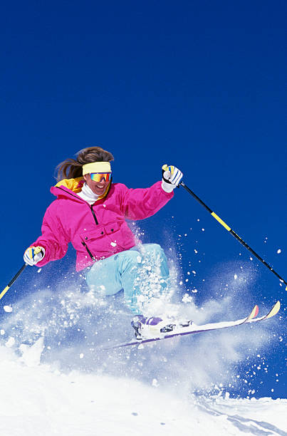 istock Beautiful Woman Snow Skiing 115933884
