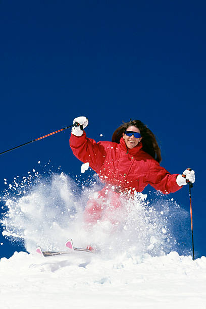 istock Beautiful Woman Snow Skiing 115933888