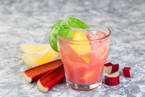 Refreshing lemonade with rhubarb, lemon, sparkling water and basil in a glass, horizontal stock photo