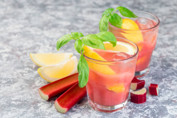 istock Refreshing lemonade with rhubarb, lemon, sparkling water and basil in a glass, horizontal, copy space 1159339585