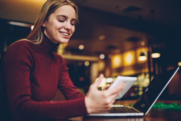 istock Happy hipster girl sharing media files via touch pad and laptop device using bluetooth connection indoors, smiling woman reading positive news in social networks via application on digital tablet 1159341287