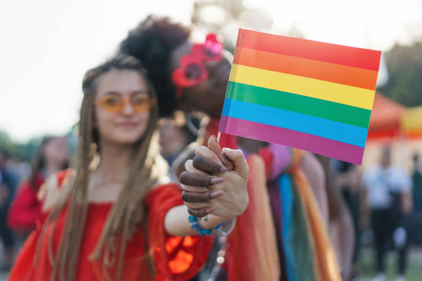 istock Interracial female couple at the pride parade 1159342115
