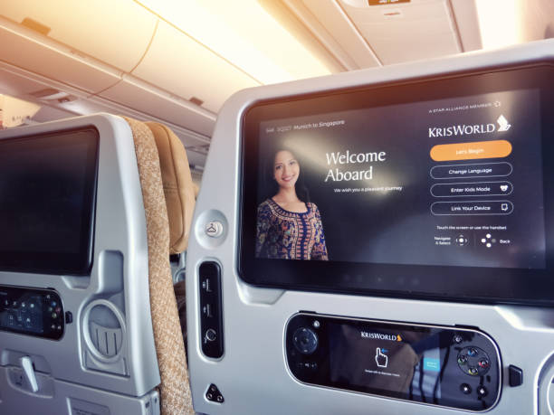 entertainment media controller and welcome screen inside Singapore airline flight economy class, Singapore stock photo